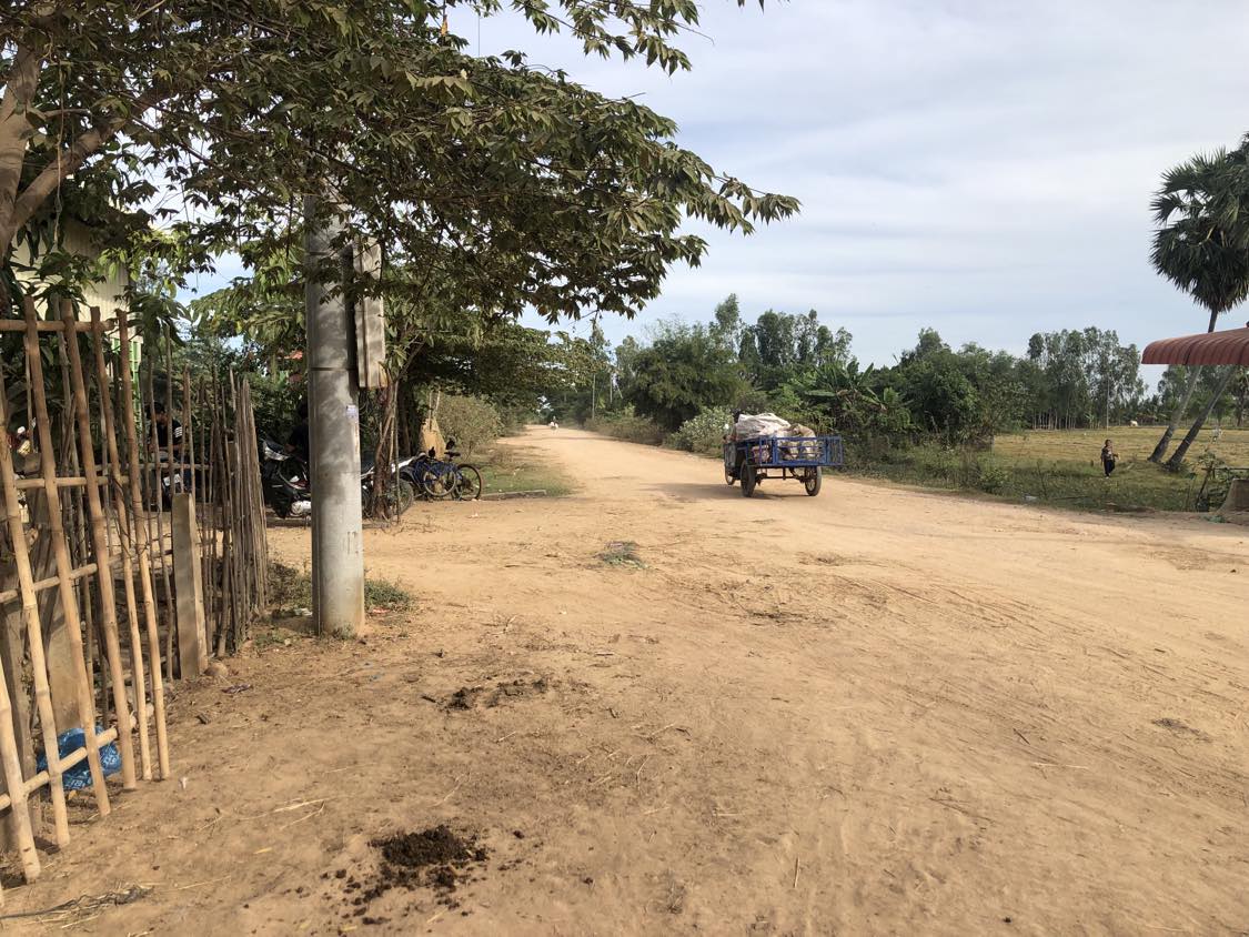 A dirt road with a vehicle on it