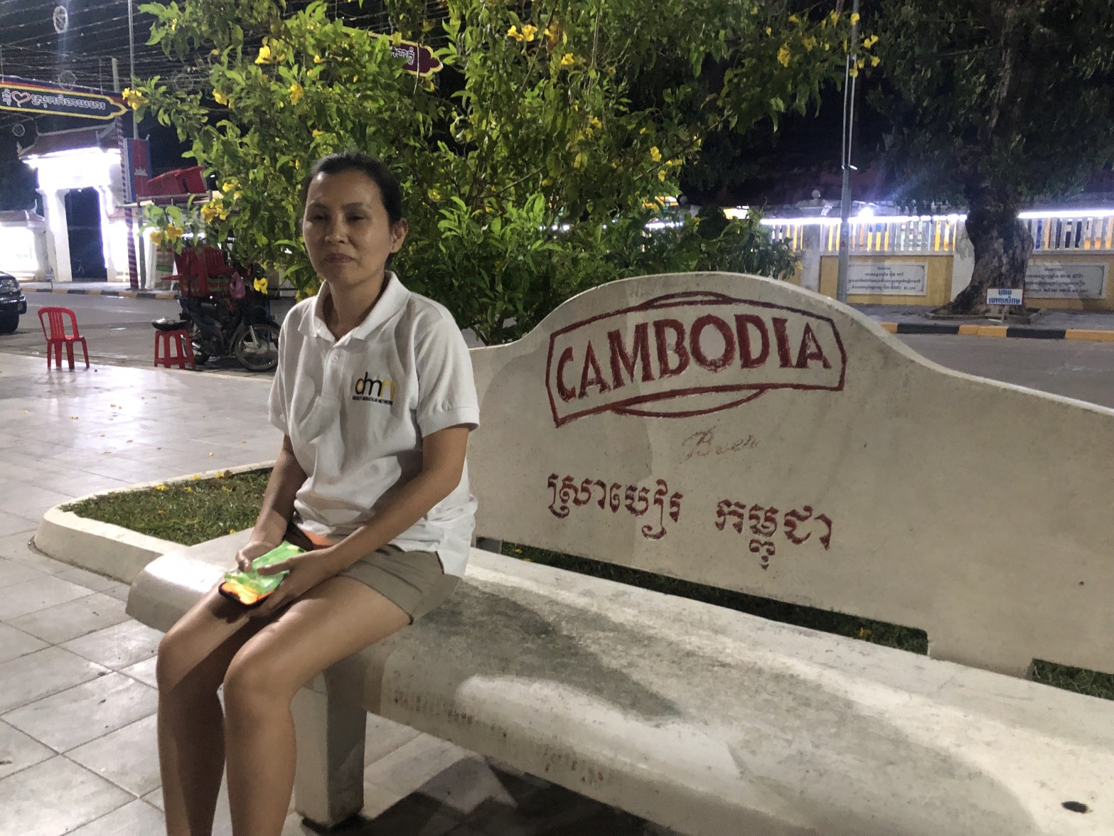A DMN staff member sitting on a bench